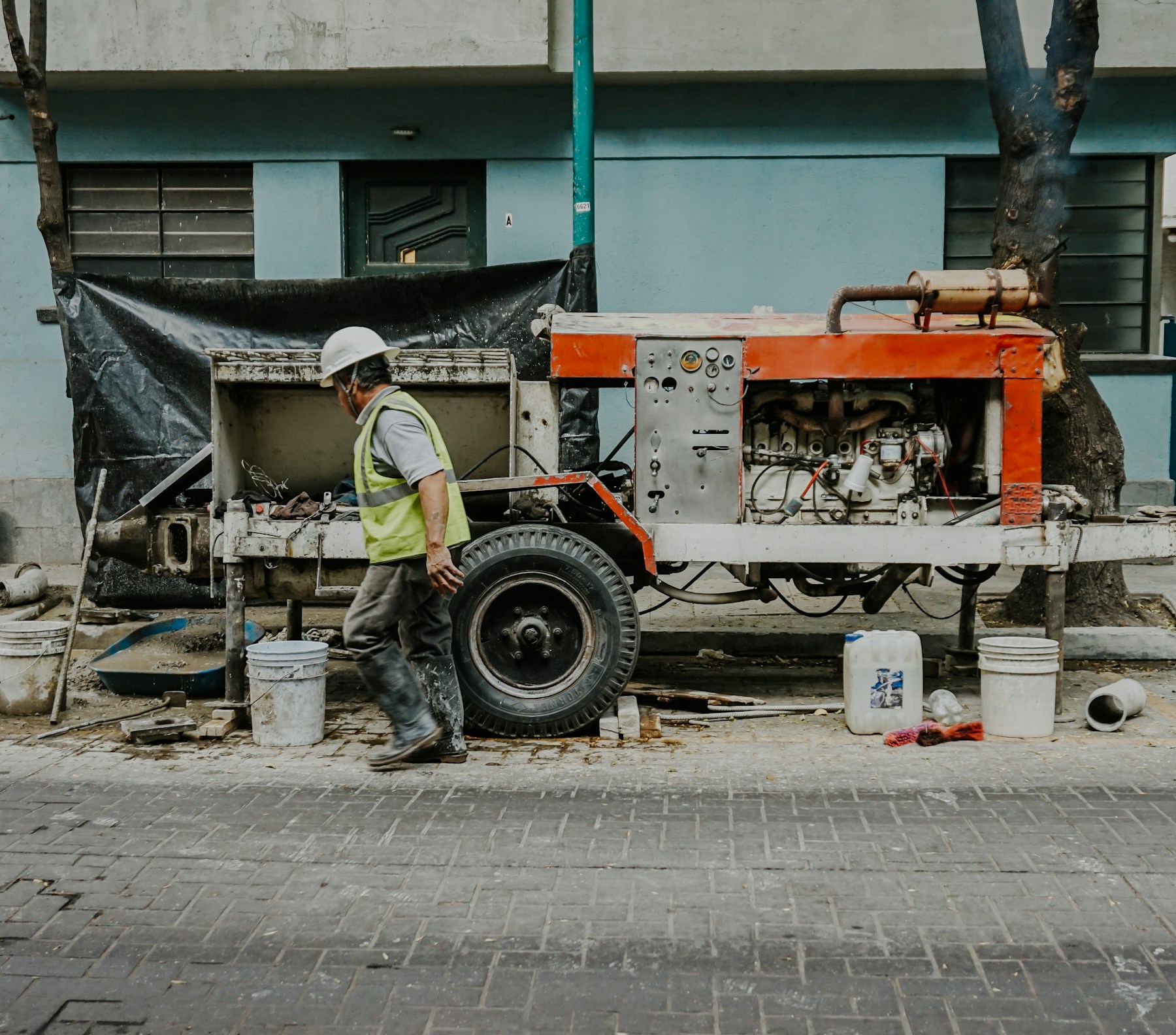 Service worker beside pumping equipment